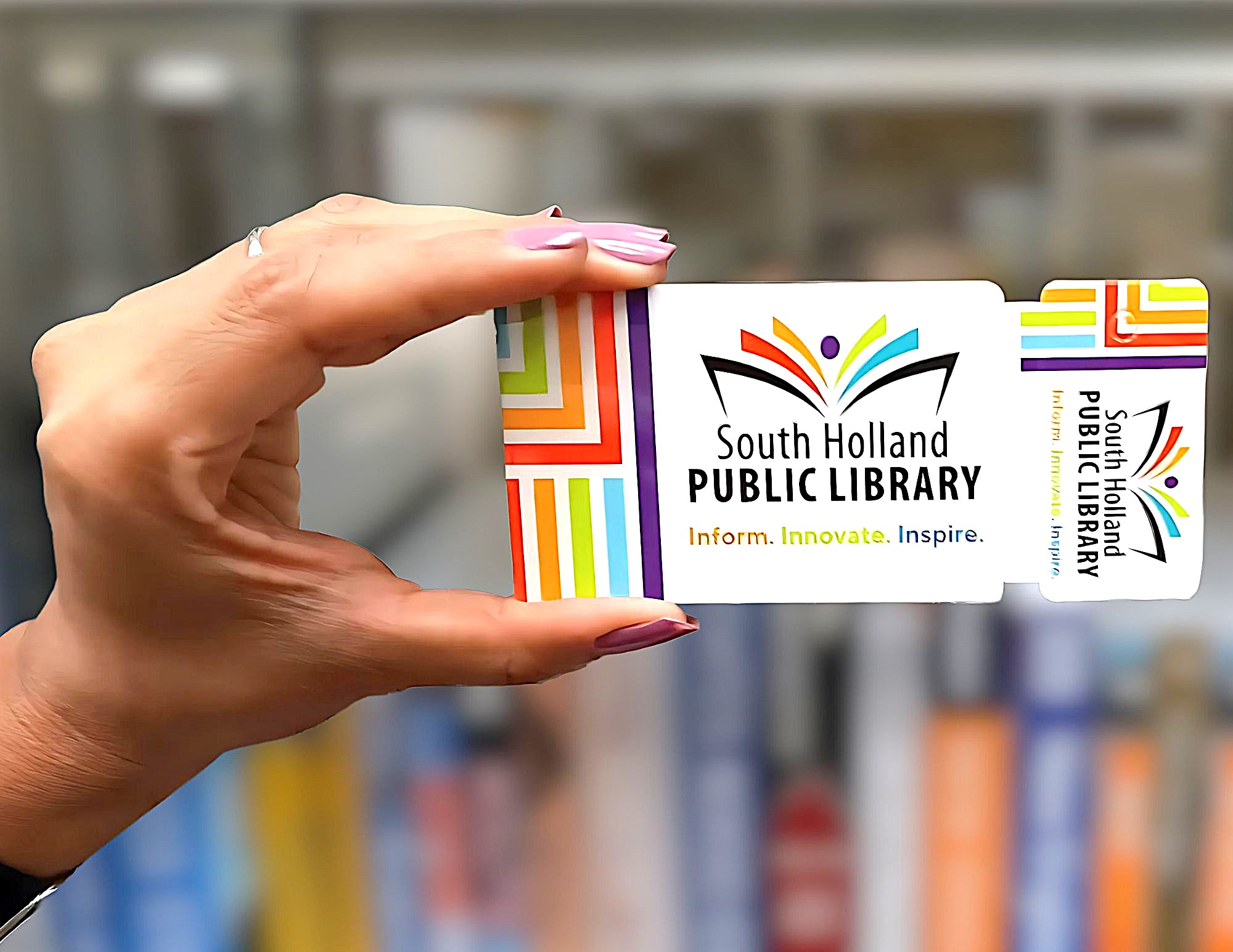 Person holding a South Holland Public Library card