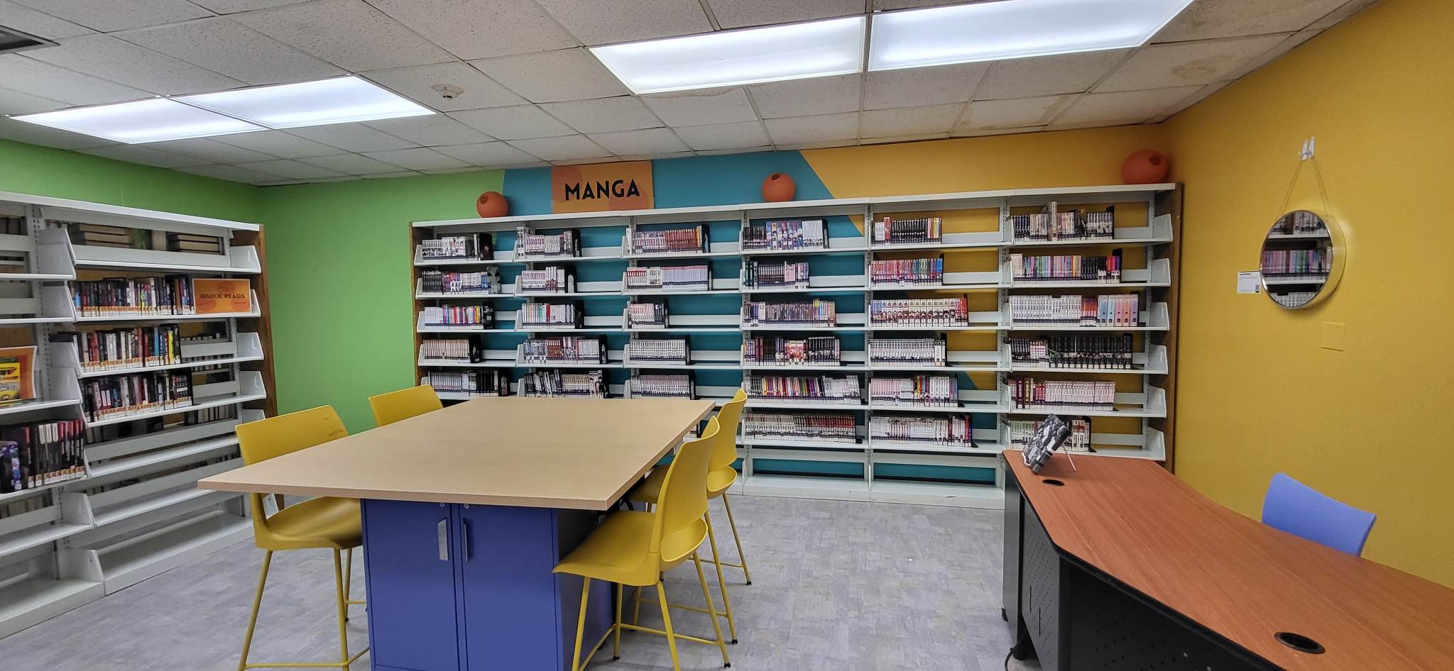 Teen Space showing a study table and bookshelves against the wall