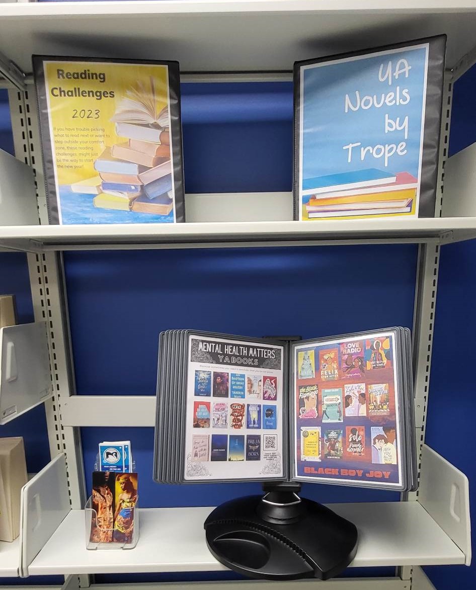 Teen Space image showing binders of reading challenges and novels by trope