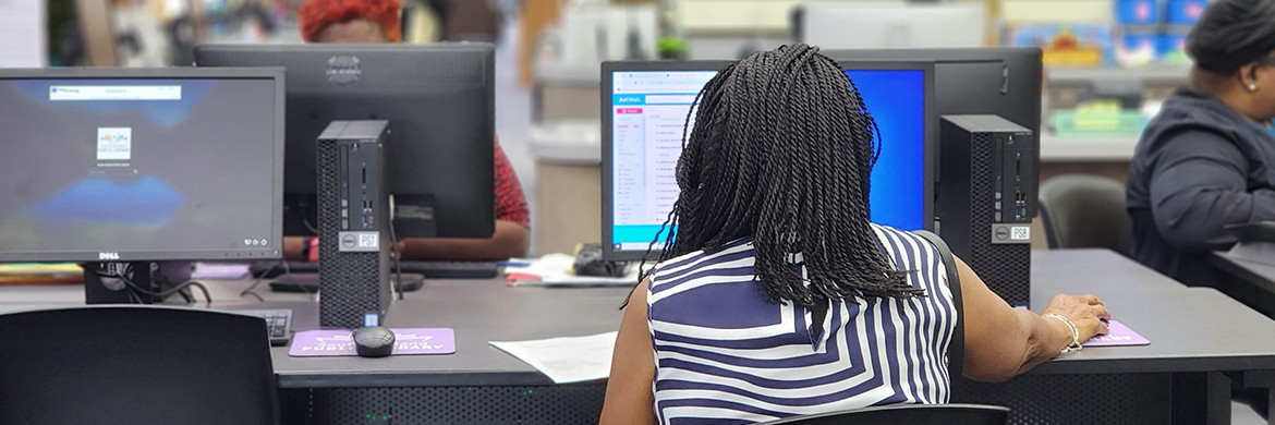 Woman using a computer in the library