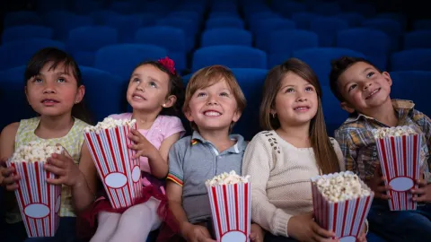 Children with popcorn watching movie