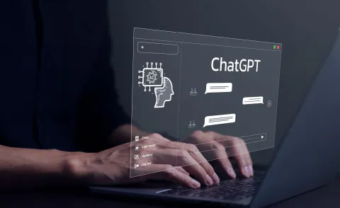 A Picture of hands typing and the screen says "Chat GPT"