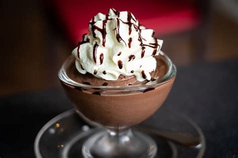 individual cup of chocolate mousse with whip cream on top