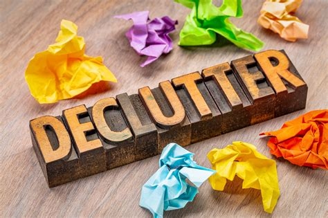 The word declutter surrounded by crumpled pieces of paper.