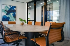 Meeting room desk and chairs and blue painting on the wall